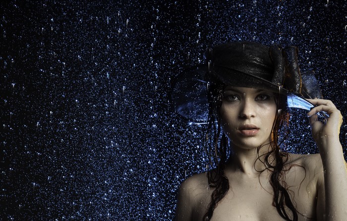 Woman in a hat in the rain