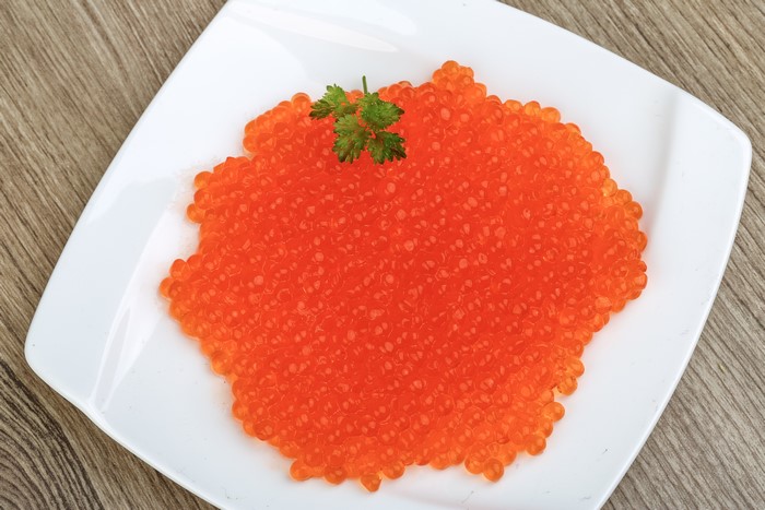 Red caviar on a white plate