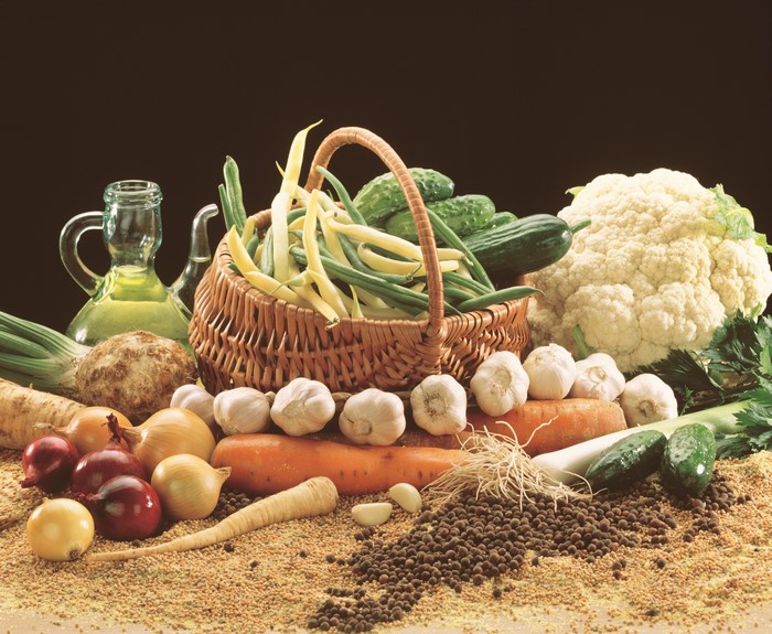 Vegetables in a wicker basket with oil and spices