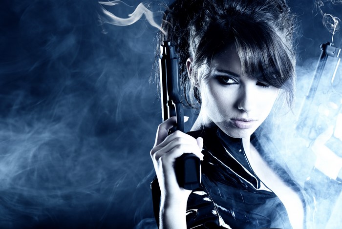 Woman with pistol in smoke
