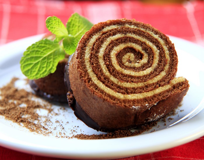 Chocolate and vanilla swirled swiss roll cake with mint