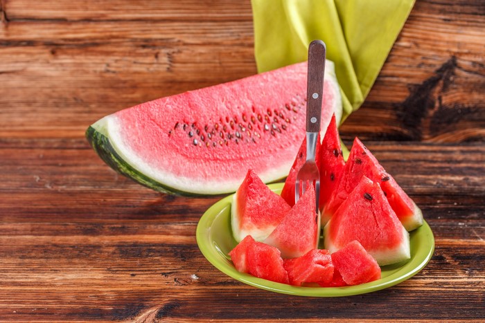 Watermelon slices on a plate with a fork