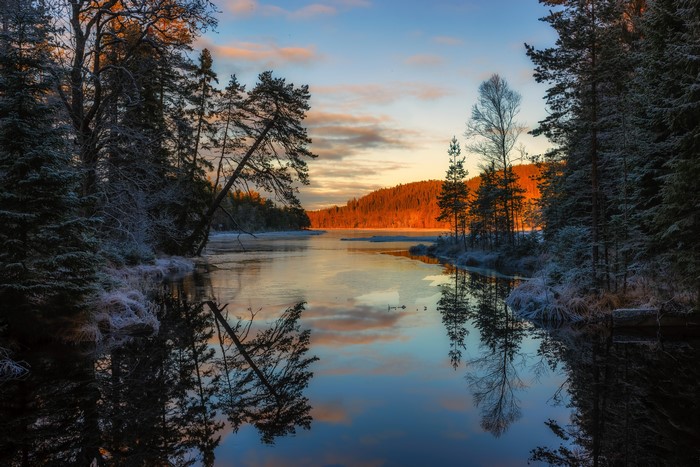Sunrise over a frozen river in Arvika, Sweden