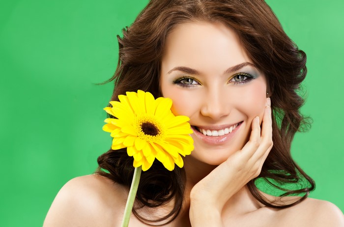 Woman with yellow Gerbera flower