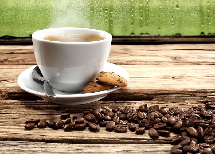 Coffee cup with cookies and coffee beans