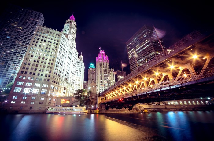 Chicago city skyline at night with bridge and river