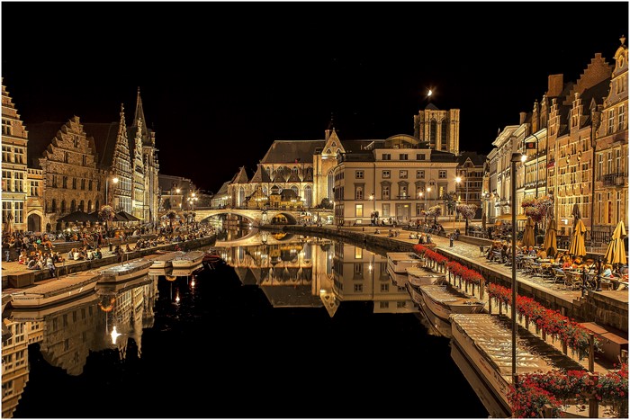 Ghent canal at night with reflections of buildings