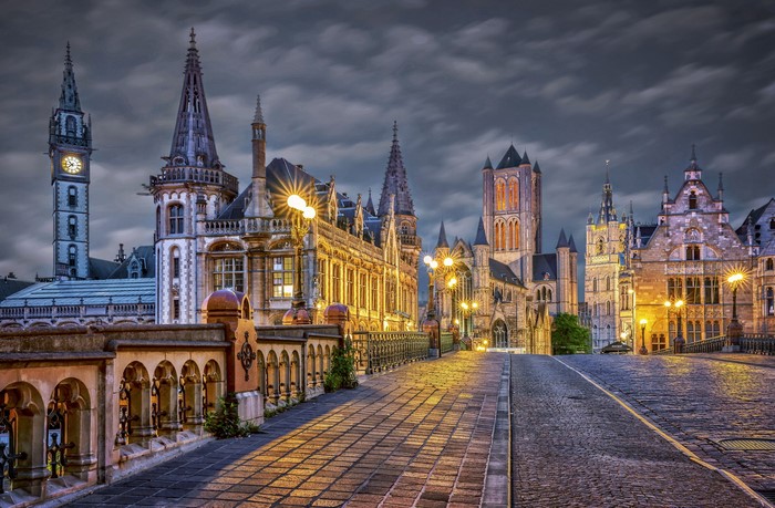 Ghent, Belgium historic buildings and bridge at dusk