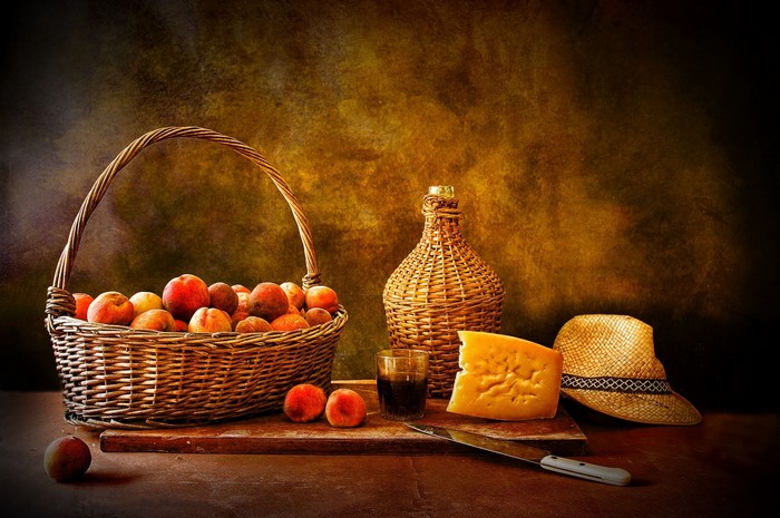 Still-life with peaches, cheese, and wine bottle