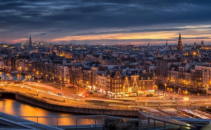 Amsterdam cityscape at dusk with canals and bridges