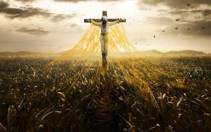Figure on a cross in a cornfield