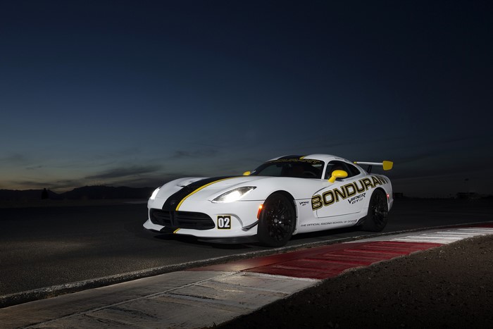 White Dodge Viper GTC on a race track at dusk