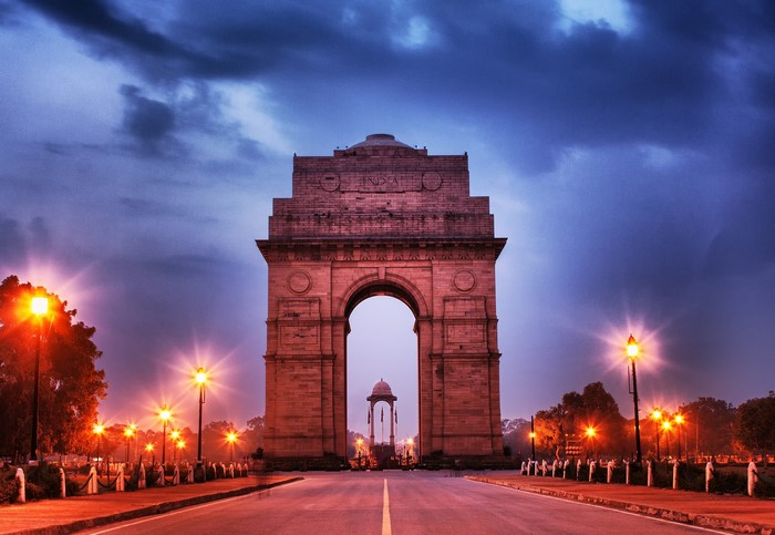 India Gate monument at dusk with street lights