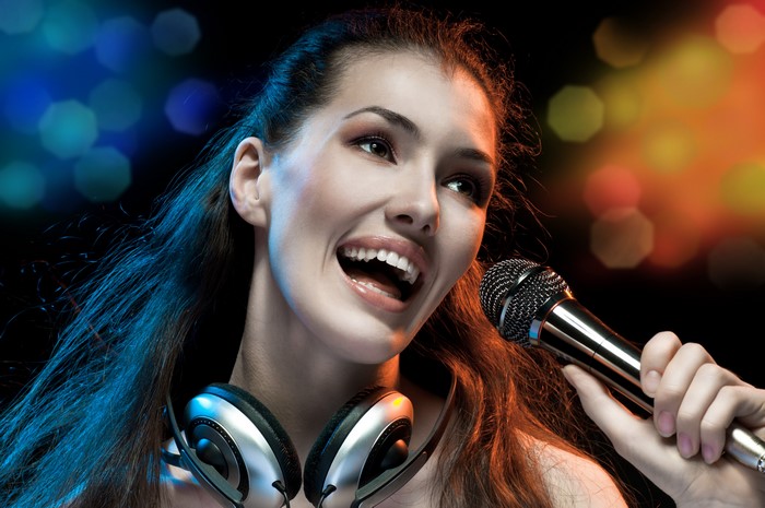 Woman singing with microphone and headphones