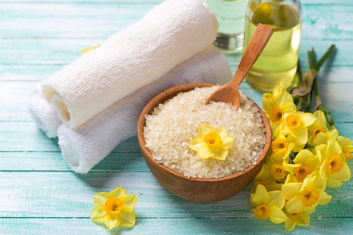 Spa setting with daffodils, salt, and towels
