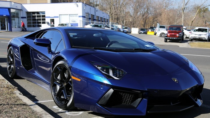 Blue Lamborghini Aventador LP700-4 parked on street