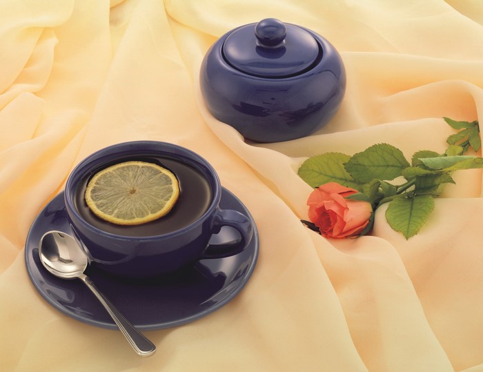 Blue teacup with lemon slice and rose