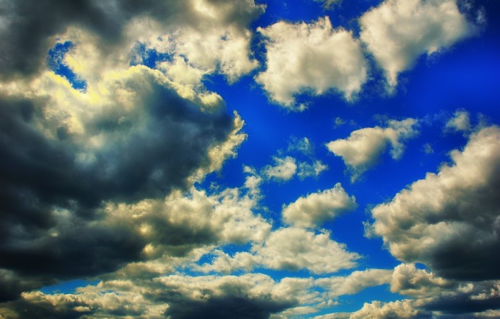 Dramatic clouds against a bright blue sky