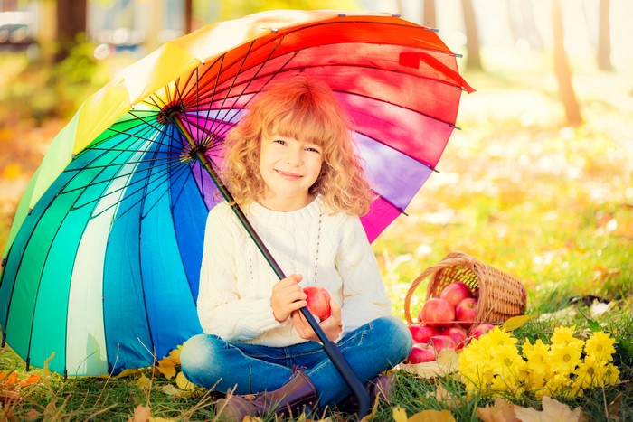 Girl with Umbrella and Apples in Autumn