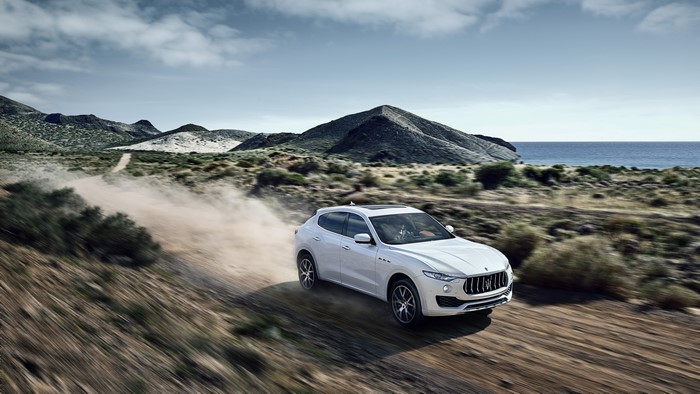 White Maserati Levante on a dirt road