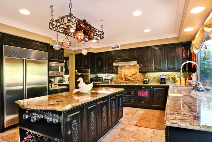 Luxurious kitchen with dark cabinets and granite countertops