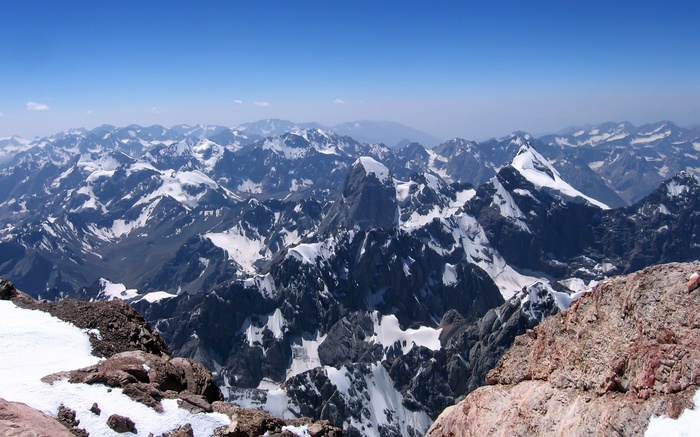 Snow-capped mountains under a clear blue sky