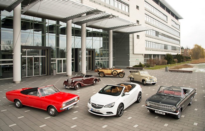 Opel Retro Cabriolets in front of a modern building