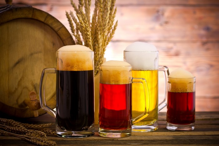Four Mugs of Beer with Wheat and Barrel