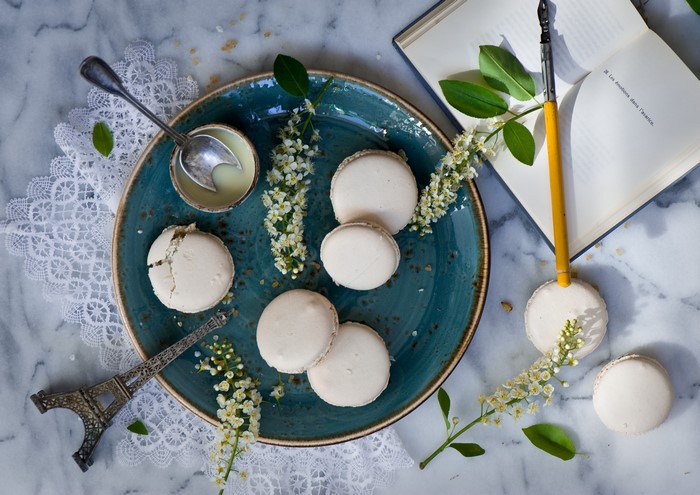 Macarons on a plate with flowers and Eiffel Tower souvenir