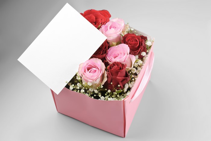 Roses in a pink box with a greeting card