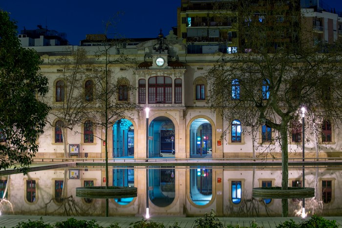 Building with arches and reflection in water at night