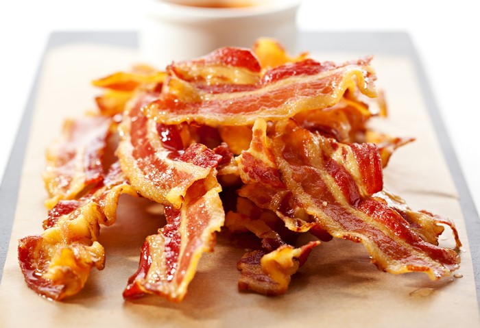 Crispy Bacon Strips on Parchment Paper
