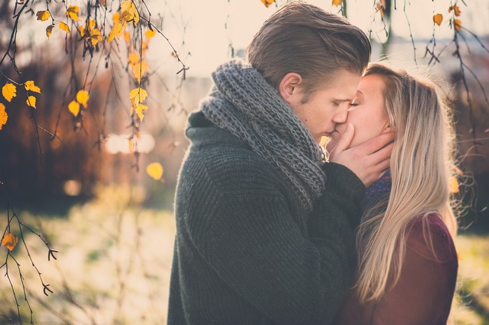 Couple kissing in autumn park