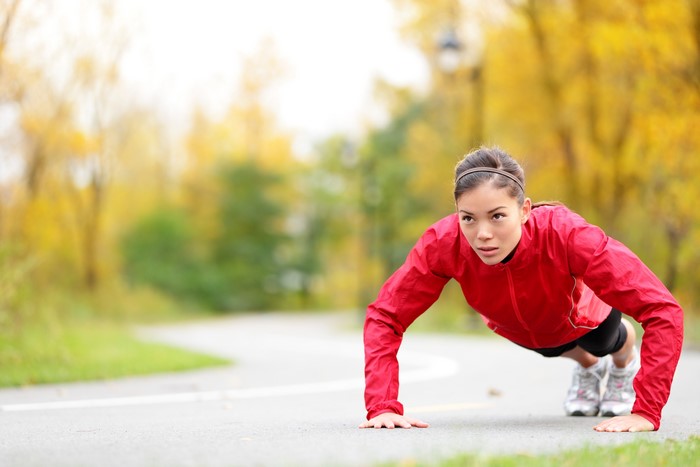 Woman doing push-ups in a park