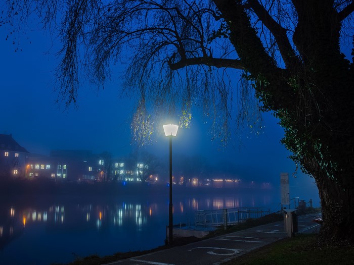 Street light by a river in Ulm, Germany at night