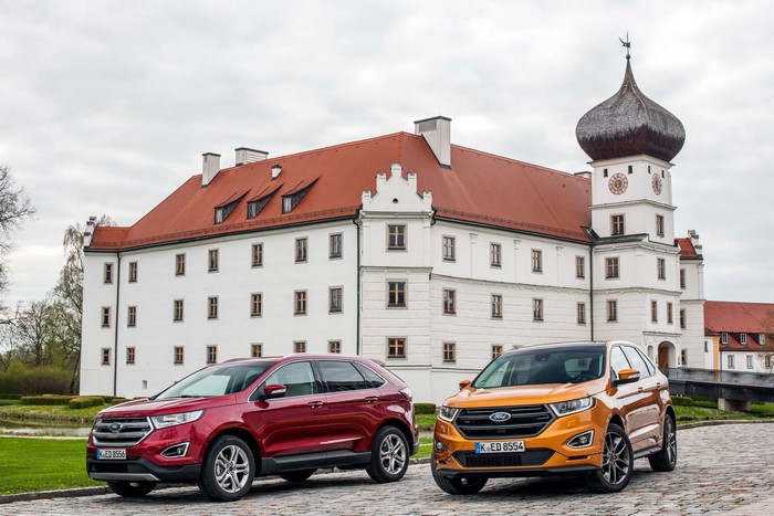 Two Ford Edge cars in front of a castle