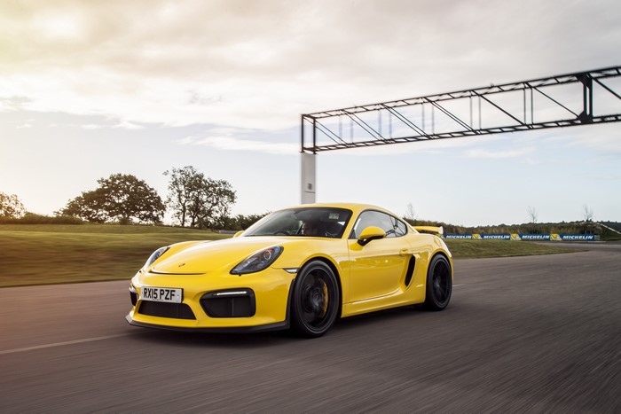 Yellow Porsche Cayman GT4 on a Track