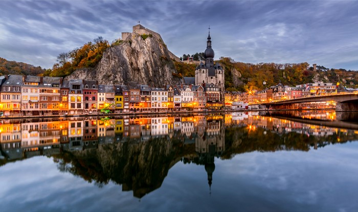 Dinant, Belgium cityscape with river and citadel at dusk
