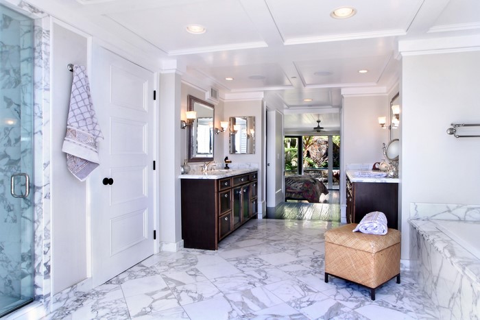 Luxury bathroom with marble floors and dual vanities