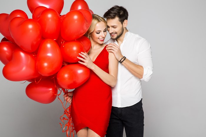 Couple with red heart balloons