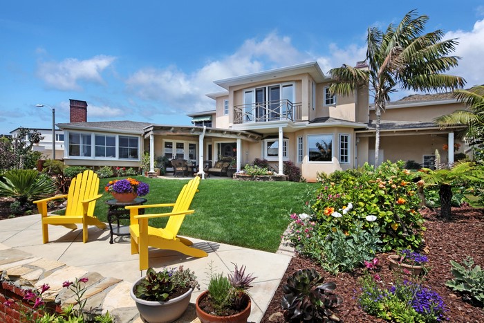 House with lawn and chairs
