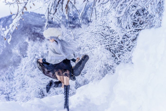 Doll wearing boots and skirt in snow