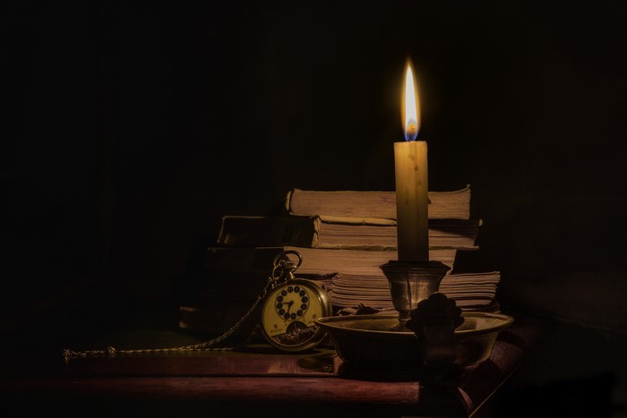 Still-life with candle and books