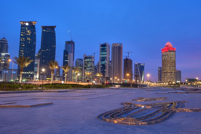 Doha Qatar skyline at dusk with modern skyscrapers