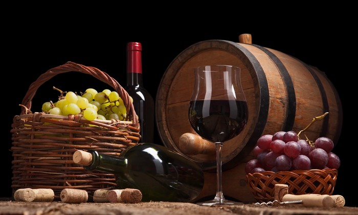 Wine barrel with grapes and wine glass