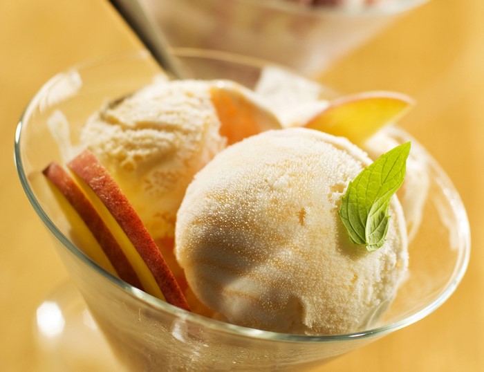Ice cream with peach slices and mint