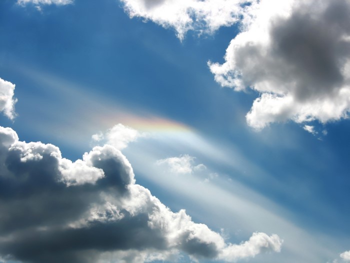 Sky with clouds and rainbow