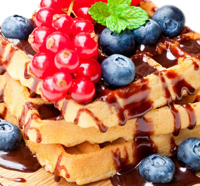 Stack of waffles with blueberries and currants