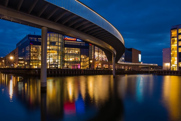 Copenhagen waterfront with bridge and buildings at night