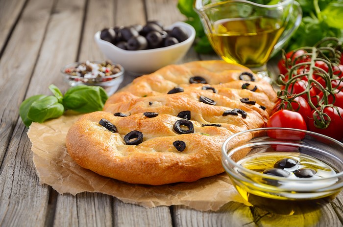 Focaccia with olives, tomatoes, basil, and olive oil